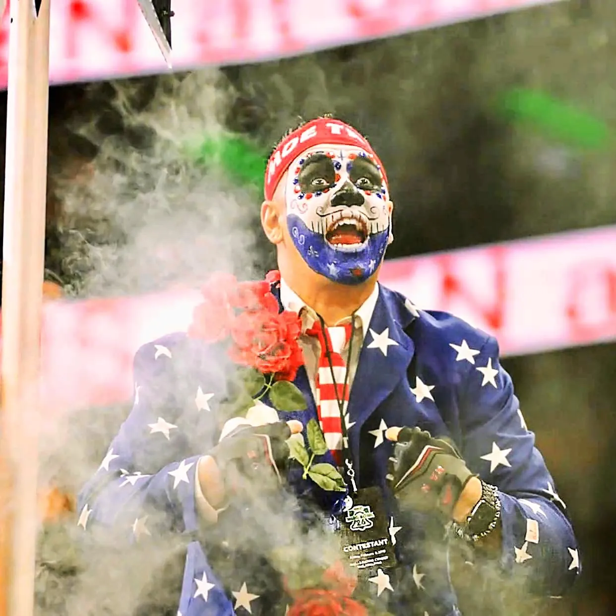 Moe Train in full skull face paint and his stars and stripes entrance suit, red roses in hand, coming through the smoke on a Wing Bowl entrance