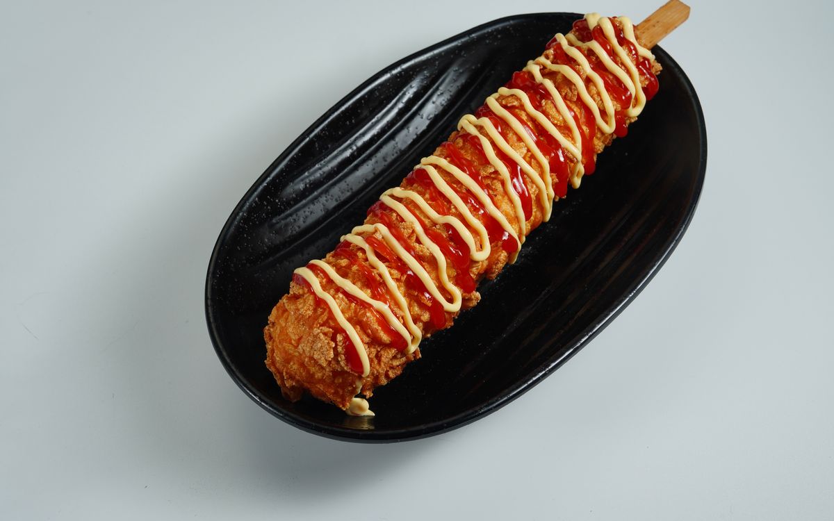 A corn dog on a stick, the fair food the Arizona State Fair covered in peanut butter and jelly