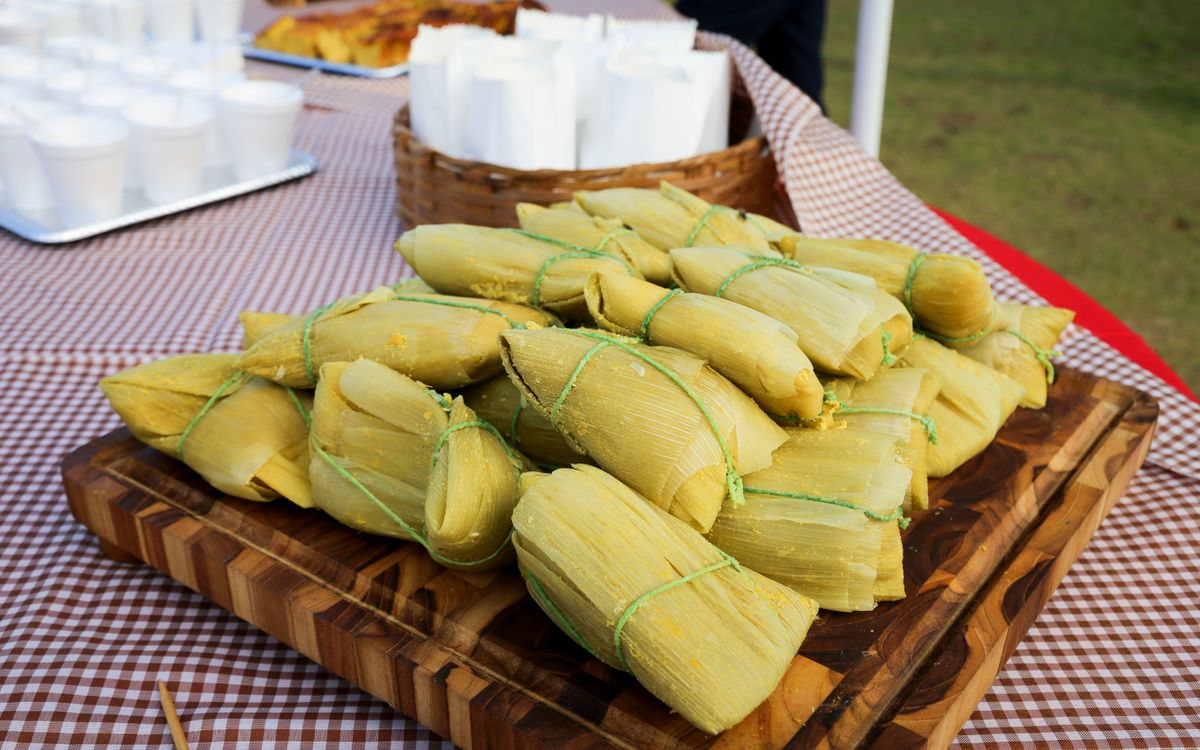 Tamales still wrapped in their corn husks, the dish at the center of the viral review stunt