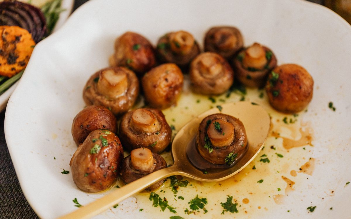 Fried mushrooms on a plate with herbs