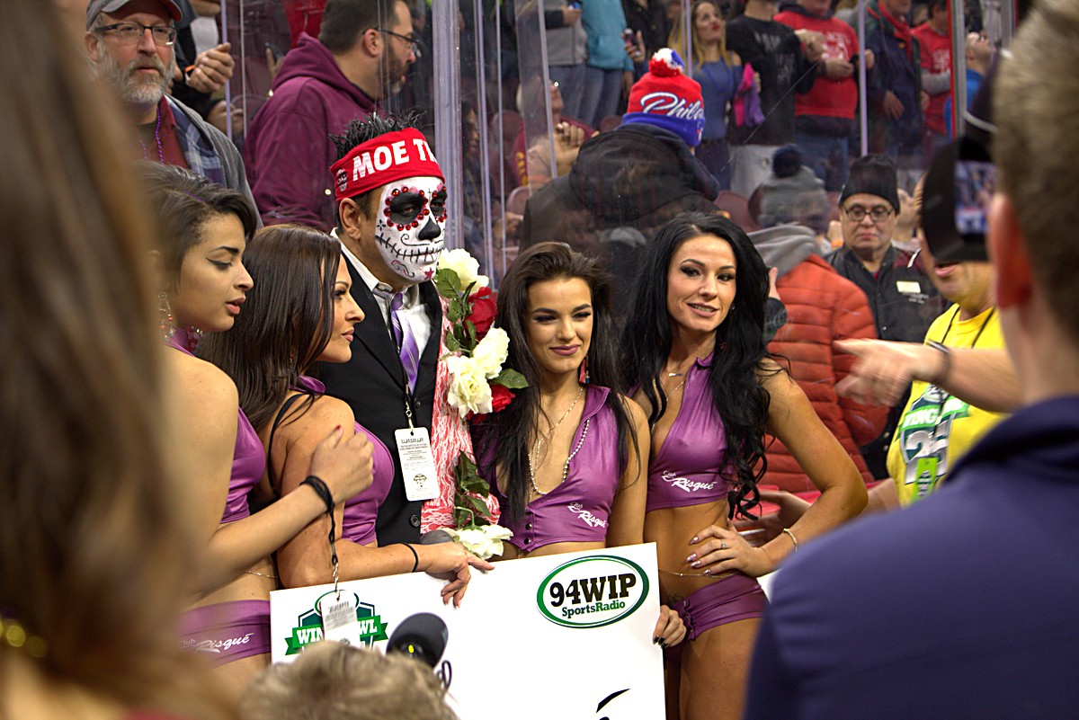 Entourage gathered at the glass barrier with the arena crowd behind at Wing Bowl 25